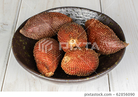 Exotic brown salak on grey wood Exotic brown salak on grey wood 62856090