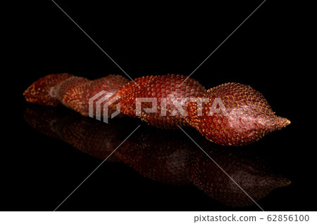 Exotic brown salak isolated on black glass Exotic brown salak isolated on black glass 62856100