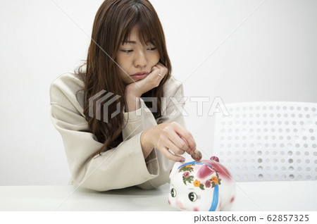 A young woman saving money A young woman saving money 62857325