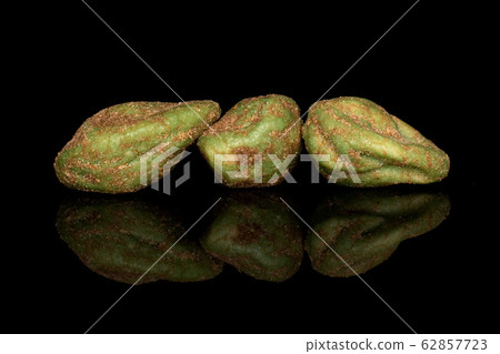 Green wasabi peanut isolated on black glass Green wasabi peanut isolated on black glass 62857723