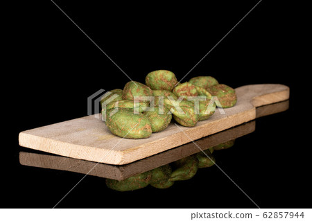 Green wasabi peanut isolated on black glass Green wasabi peanut isolated on black glass 62857944