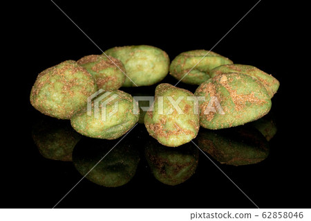 Green wasabi peanut isolated on black glass Green wasabi peanut isolated on black glass 62858046