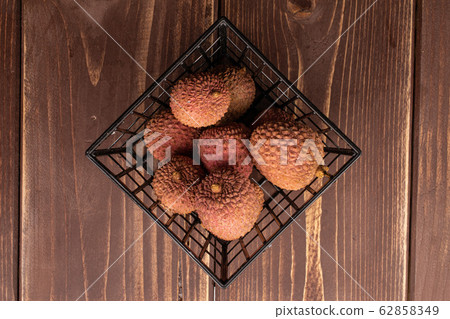 Fresh lychee fruit on brown wood Fresh lychee fruit on brown wood 62858349