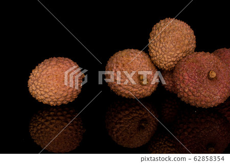 Fresh lychee fruit isolated on black glass Fresh lychee fruit isolated on black glass 62858354