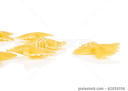 Yellow farfalle pasta isolated on white Yellow farfalle pasta isolated on white 62858356