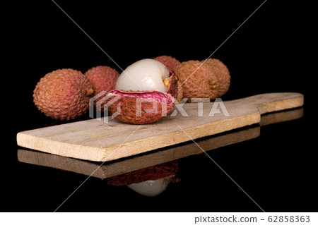 Fresh lychee fruit isolated on black glass Fresh lychee fruit isolated on black glass 62858363