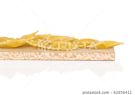 Yellow farfalle pasta isolated on white Yellow farfalle pasta isolated on white 62858412