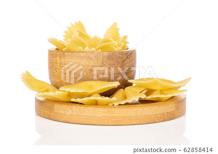 Yellow farfalle pasta isolated on white Yellow farfalle pasta isolated on white 62858414
