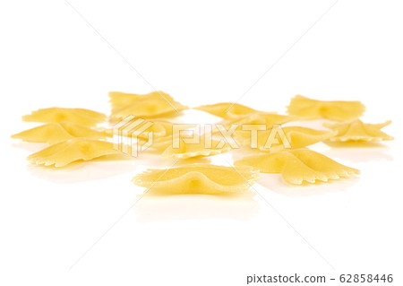 Yellow farfalle pasta isolated on white Yellow farfalle pasta isolated on white 62858446