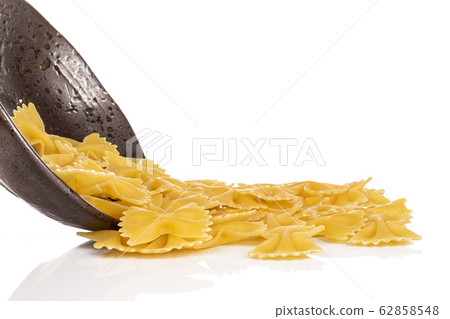 Yellow farfalle pasta isolated on white Yellow farfalle pasta isolated on white 62858548