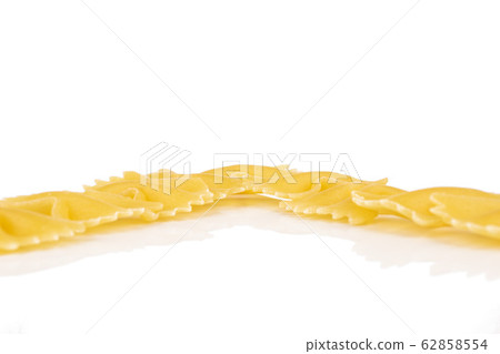 Yellow farfalle pasta isolated on white Yellow farfalle pasta isolated on white 62858554