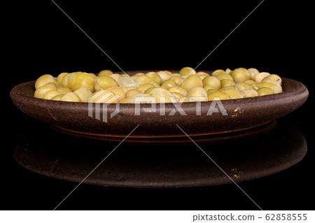 Canned pea isolated on black glass Canned pea isolated on black glass 62858555