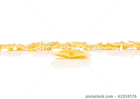 Yellow farfalle pasta isolated on white Yellow farfalle pasta isolated on white 62858576