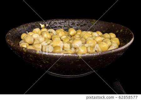 Canned pea isolated on black glass Canned pea isolated on black glass 62858577