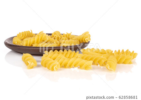 Yellow fusilli pasta isolated on white Yellow fusilli pasta isolated on white 62858681