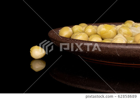 Canned pea isolated on black glass Canned pea isolated on black glass 62858689