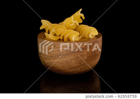 Yellow fusilli pasta isolated on black glass Yellow fusilli pasta isolated on black glass 62858739