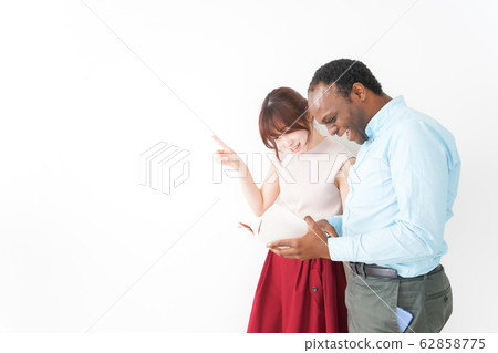 A young woman giving directions for foreign tourists A young woman giving directions for foreign tourists 62858775