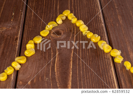 Yellow canned corn on brown wood Yellow canned corn on brown wood 62859532