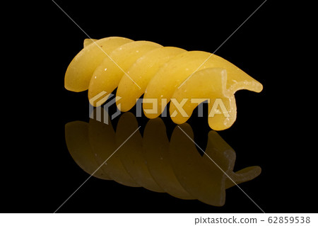 Yellow fusilli pasta isolated on black glass Yellow fusilli pasta isolated on black glass 62859538