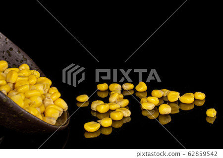 Yellow canned corn isolated on black glass Yellow canned corn isolated on black glass 62859542
