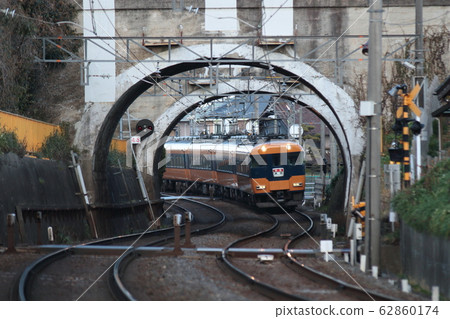 A Kintetsu 12200 series express train approaches after passing through an S-curve and a retro overpass on the Meitetsu Nagoya Line A Kintetsu 12200 series express train approaches after passing through an S-curve and a retro overpass on the Meitetsu Nagoya Line 62860174
