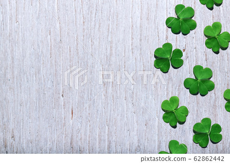 Pattern of shamrock leaves on shabby white wooden background with free copy space. St. Patrick's Day. 62862442