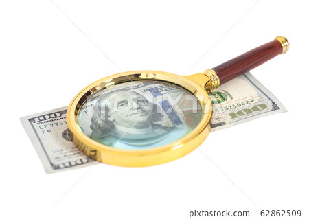 Hundred dollar banknote under magnifying glass 62862509