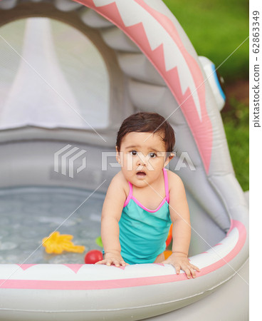 Surprised baby girl in swimming pool Surprised baby girl in swimming pool 62863349