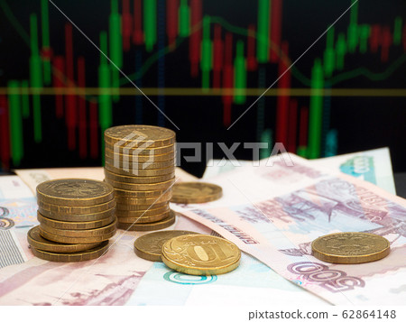 Coin piles on the trading chart background 62864148