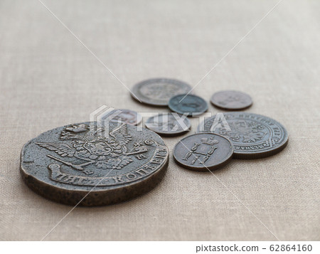 Old coins on the canvas background Old coins on the canvas background 62864160