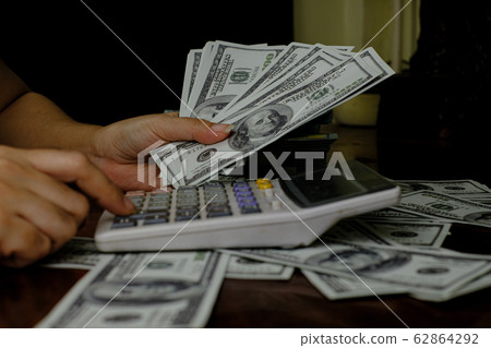 Stack of 100 US dollars banknotes at blur background Stack of 100 US dollars banknotes at blur background 62864292