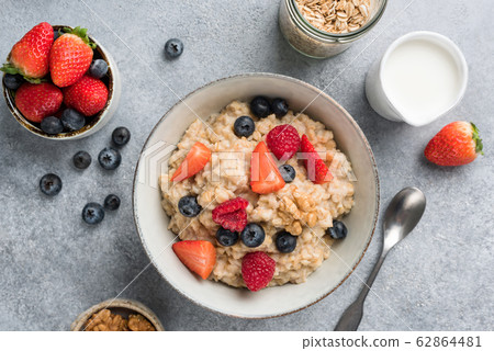 Bowl of oatmeal porridge with summer berries Bowl of oatmeal porridge with summer berries 62864481
