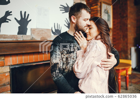 Couple near fireplace 62865036