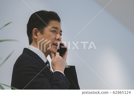 business smartphone calls businessmen in their 50s worried 62865124