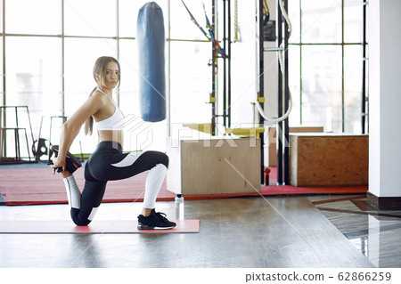 Sports girl training in a morning gym Sports girl training in a morning gym 62866259