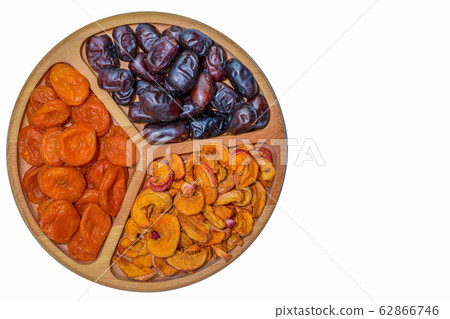 Dried fruits in a wooden bowl on a white background 62866746
