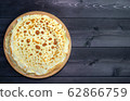 Russian pancakes on a wooden background 62866759