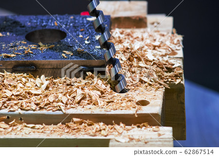 Steel boer drill a hole in a wooden board. Variety 62867514