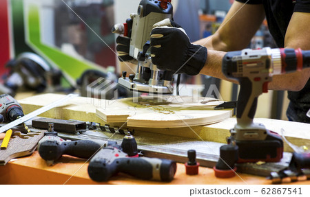 Worker grinds the wood of angular grinding machine Worker grinds the wood of angular grinding machine 62867541