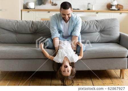 Happy dad have fun playing with little daughter Happy dad have fun playing with little daughter 62867927