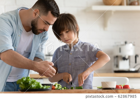 Loving father and little son cooking together at home Loving father and little son cooking together at home 62867985