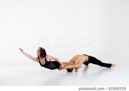Duo Of Acrobats Showing hand to hand Trick, Isolated On White 62868550
