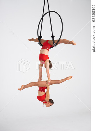 Twins female circus duo on the Aerial hoop isolated on white Twins female circus duo on the Aerial hoop isolated on white 62868562