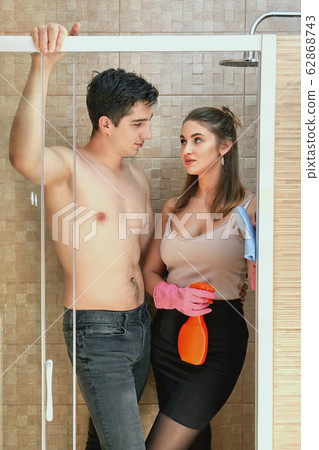 The hotel guest flirts with an attractive maid. The hotel guest flirts with an attractive maid. 62868743
