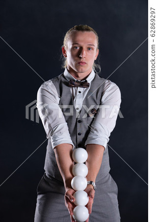 Juggler wearing a suit like a businessman with white balls. concept of success and management 62869297