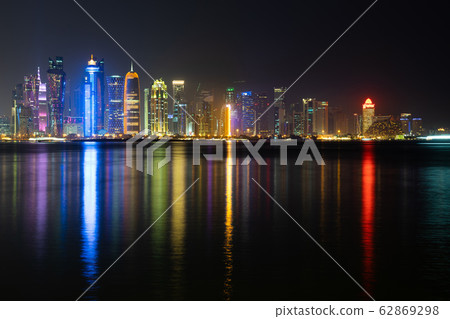 Vibrant Skyline of Doha at Night as seen from the opposite side of the capital city bay at night 62869298