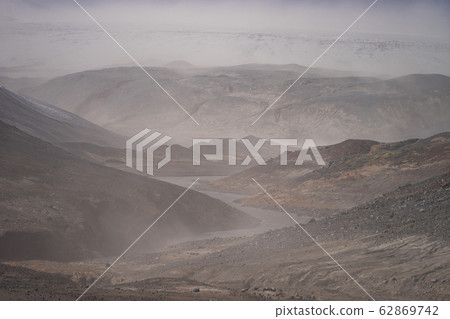 Volcanic landscape during ash storm on the Fimmvorduhals hiking trail. Iceland Volcanic landscape during ash storm on the Fimmvorduhals hiking trail. Iceland 62869742