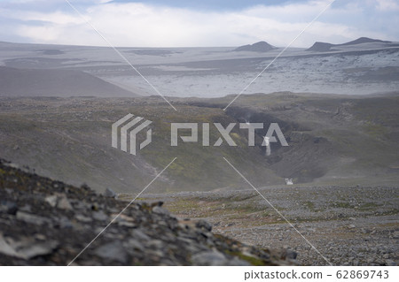 Volcanic landscape with glacier, rocks and ash on the Fimmvorduhals hiking trail. Iceland Volcanic landscape with glacier, rocks and ash on the Fimmvorduhals hiking trail. Iceland 62869743