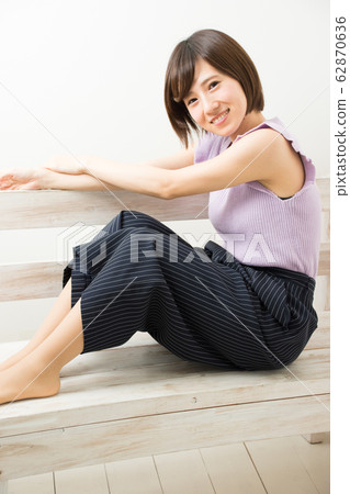 一個女人坐在長椅上 62870636